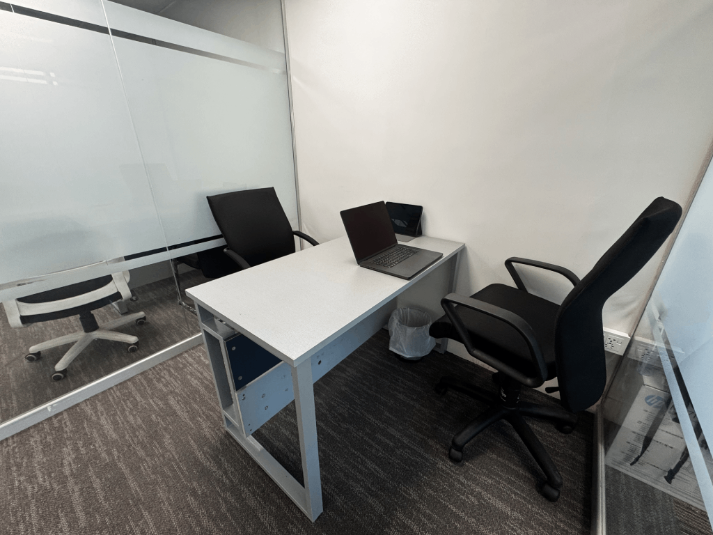 Meeting room with conference table and green chairs